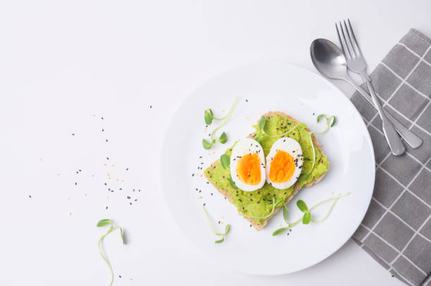 istock Bread with avocado , vegetables fruit and egg on white background , Healthy breakfast concept 1437256798