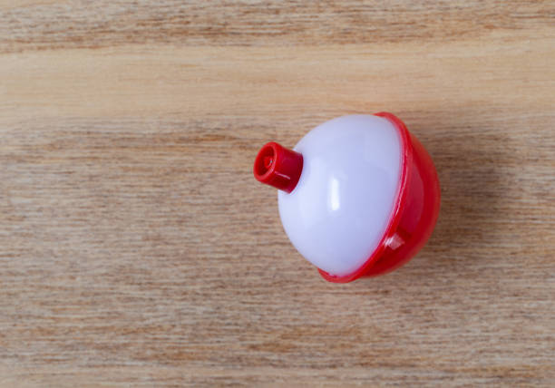istock Single red and white plastic fishing bobber top view 1437256901