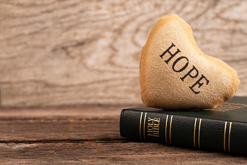 Bible and heart with word HOPE