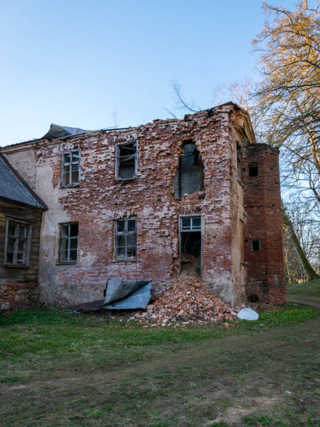 istock view of the old Augstroze manor, half-ruined side of red bricks, empty windows 1437258483
