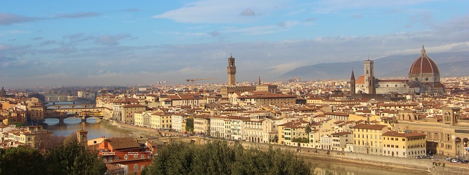 View of the city of Florence, Italy from Piazzale Michelangelo. The signature of Florence is its red rooftops, and some of the most popular landmarks are Ponte Vecchio and the famous cathedral, the Duomo Santa Maria del Fiore.
