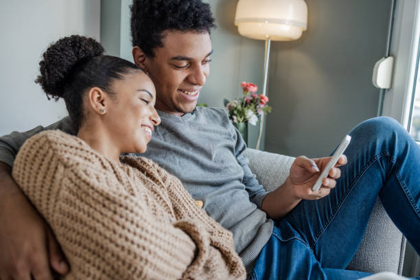 istock Portrait of a happy couple using smart phone 1437261429