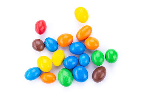 Colorful chocolate buttons, on white background. Chocolate coated Peanuts.
