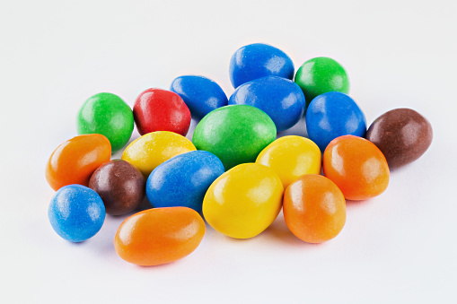 Muti-Colored Gum Drops candy in a glass candy dish against a white background