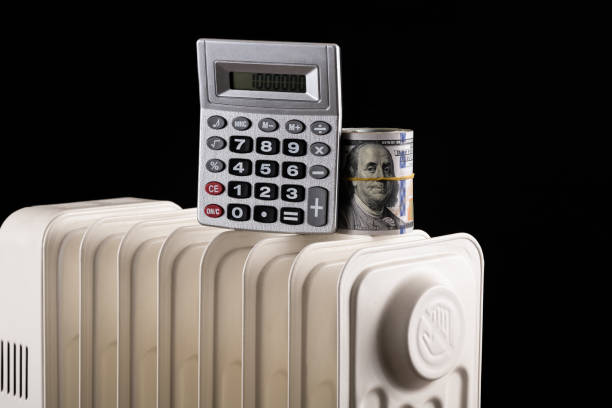 istock Conceptual plot about heating prices with american dollars, calculator and electric radiator on black background 1437264914