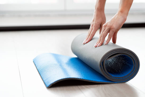 istock Woman folding mat, workout at home concept 1437265091