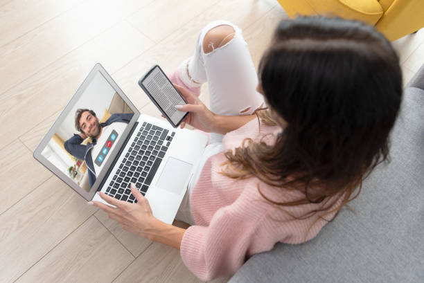 Young woman using video chat at home Woman is having a video call on laptop. Young woman using video chat at home Virtual Assistants Improve Collaboration in Remote Work Environments stock pictures, royalty-free photos & images