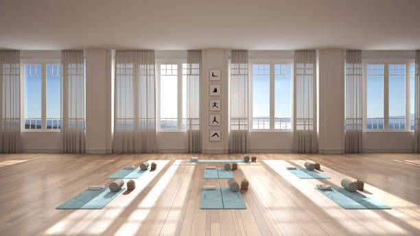 istock Empty yoga studio interior design, classic space, parquet floor, walls with stucco, mats, pillows and accessories, ready for yoga practice, meditation, panoramic window, sea view 1437265905