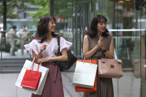 istock Beautiful young wmen enjoying shopping 1437265906