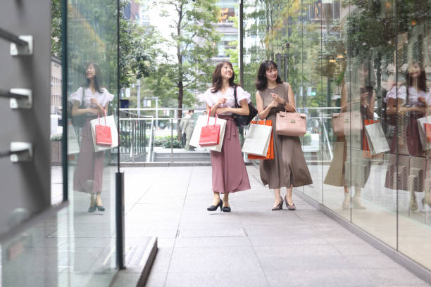 istock Beautiful young wmen enjoying shopping 1437266472