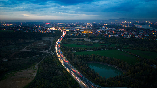 Aerial view over illuminated city at dusk - drone point of view