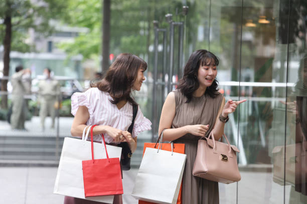 istock Beautiful young wmen enjoying shopping 1437266868