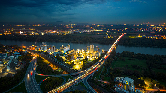 Highway interchange and industrial district at dusk - aerial view