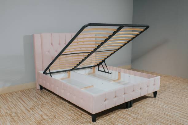 istock Pink bed with a storage space revealed by lifting the wooden slatted base 1437269499