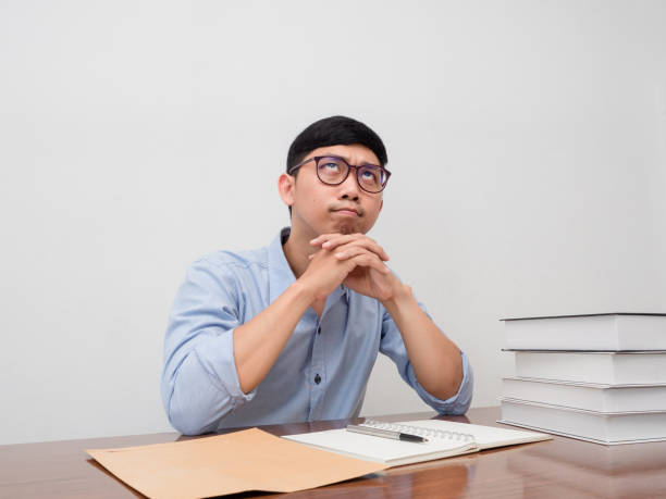 istock Businessman wear glasses sit at working table gesture thoughtful about work 1437274094