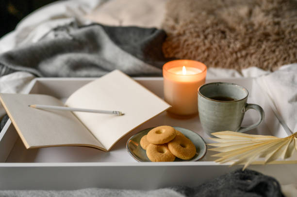 istock cozy autumn composition with candle, mug, coffee and cookies on bed 1437275276