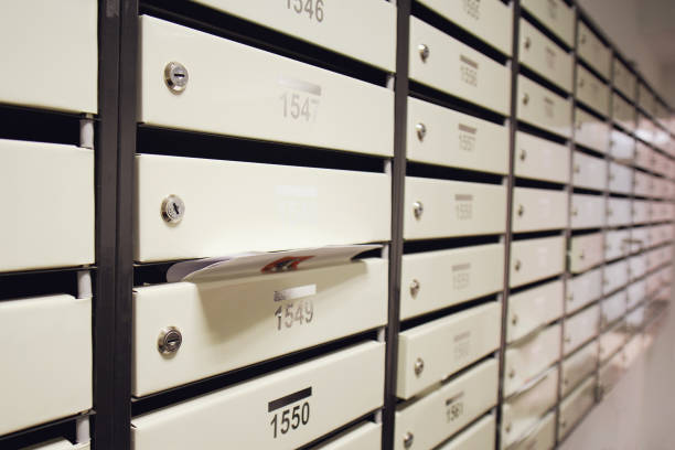 istock Mailboxes filled with letters and bills in an apartment building. An overflowing postbox in the hallway of the house 1437275313