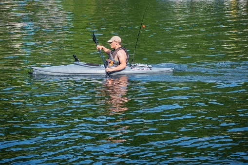 Morgantown, WV, United States – June 09, 2020: Man in a fishing kayak on Cheat Lake in Morgantown, West Virginia