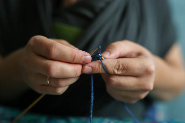 istock Hands with knitting close-up, concept hobby 1437277876
