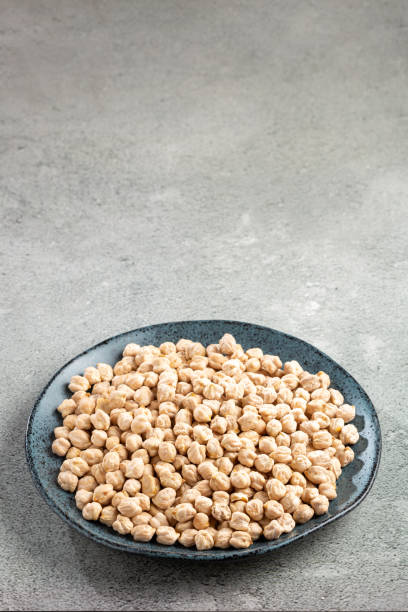 istock Raw chickpeas in the plate on the table. 1437278033