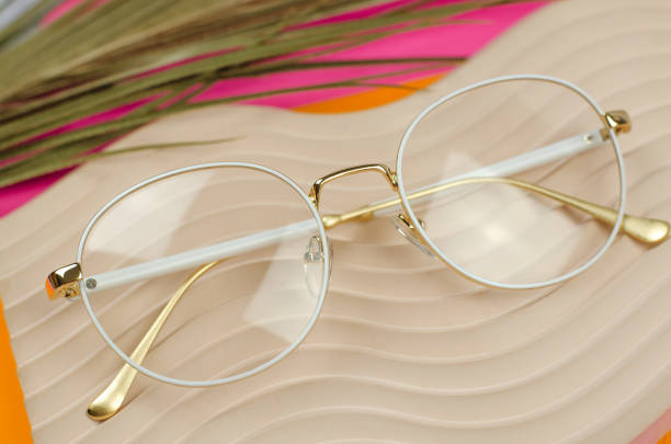 istock Stylish women's glasses in a white frame on a beige plaster podium 1437279209