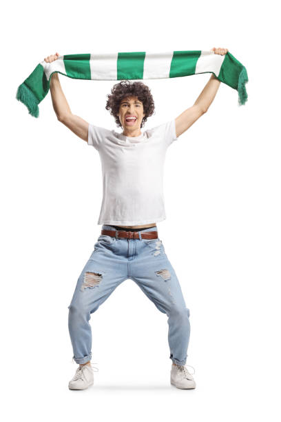 istock Happy young man cheering with a green and white scarf 1437281348