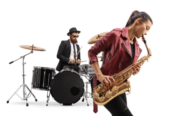 istock Young female playing a saxophone and a man playing drums in the back 1437282110