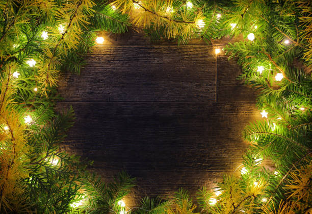 Round Christmas Frame made with Branches and White Lights stock photo