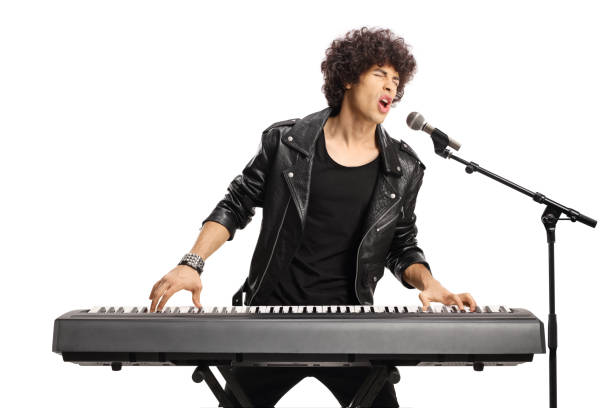 istock Young man with curly hair playing a digital piano and singing 1437282415