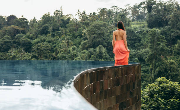 istock Young woman in infinity pool at luxury resort 1437282698