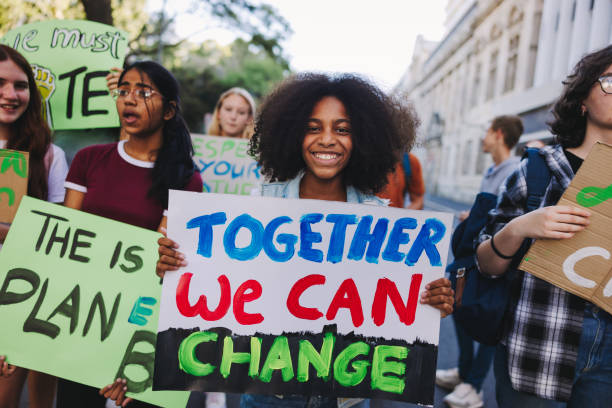 istock Cheerful young girl holding a poster during a climate strike 1437285529