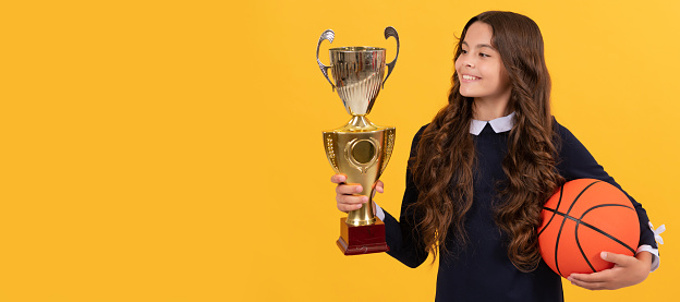 sport achievement award. teen girl with basketball ball and champion cup. Horizontal poster of isolated child face, banner header, copy space
