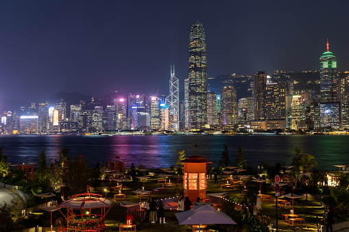 Hong Kong - October 28, 2022 : West Kowloon Waterfront Promenade on the background of Victoria Harbour and the Hong Kong skyline.