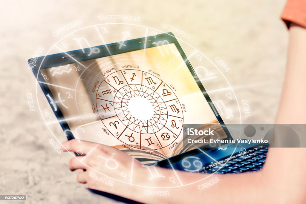 astrological forecast. Girls sits with a laptop on the beach and looks at the astrological chart. Forecast for the future astrological forecast. Girls sits with a laptop on the beach and looks at the astrological chart. Forecast for the future for all signs of the zodiac Astrology Stock Photo