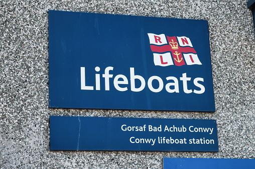 Conwy, UK- July 16, 2022: The sign for Conwy Lifeboat station at Conwy harbor in Northern Wales.