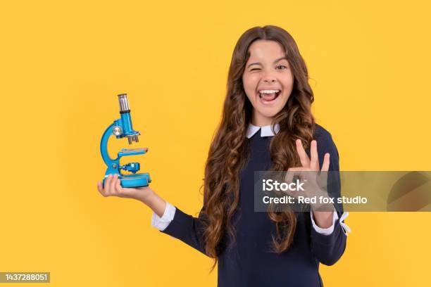 Happy Winking Child Hold Microscope For School Education Show Ok Gesture Back To School Stock Photo - Download Image Now