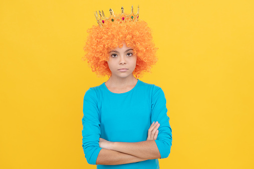 serious teen girl in fancy clown wig wear queen crown, egocentric.