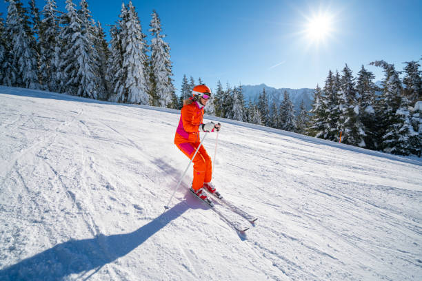 istock Woman skiing on empty ski slope on sunny day 1437289809