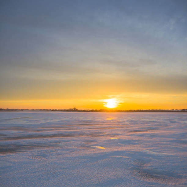 istock frozen snowbound lake at the sunset 1437290243