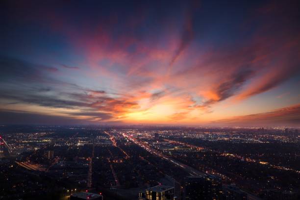 Summer sunset over city of Toronto, Canada A rooftop view of a gorgeous sky over city lights etobicoke stock pictures, royalty-free photos & images