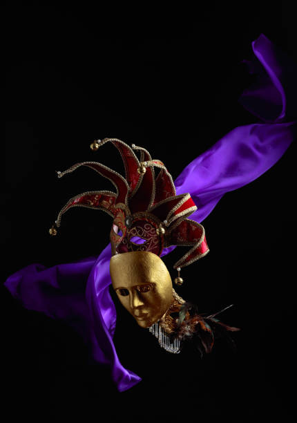 Old carnival masks with flutters purple cloth.