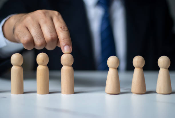 istock Executives use their fingers to touch wooden dolls (management concepts in the organization). 1437292842
