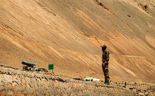 Ladakh, India - June 18,2022: Indian Army solder on duty at mountain range at Ladakh, highest plateau in India