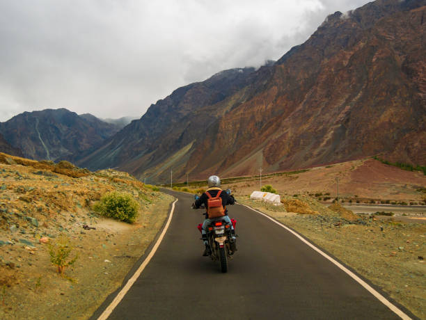 Ladakh, India - June 26, 2022 : Bikers enjoying beautiful scenic view between Diskit and Khardung La Pass in Nubra Valley, Leh Ladakh, Jammu and Kashmir, India.