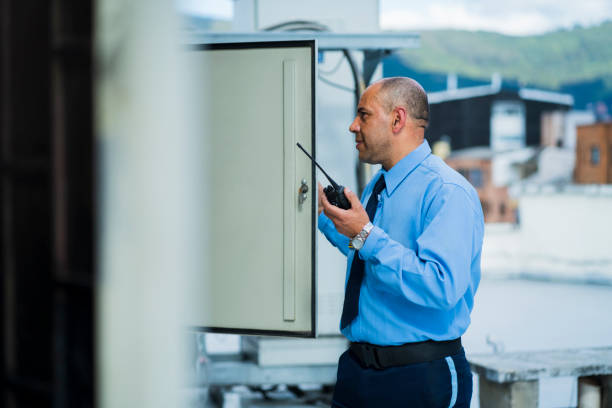 Watchmen aged between 40-50 years old are checking electrical equipment of the foundation