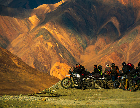 Ladakh, India - June 26, 2022 : Bikers enjoying beautiful scenic view between Diskit and Khardung La Pass in Nubra Valley, Leh Ladakh, Jammu and Kashmir, India.