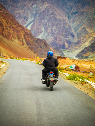 Ladakh, India - June 26, 2022 : Bikers enjoying beautiful scenic view between Diskit and Khardung La Pass in Nubra Valley, Leh Ladakh, Jammu and Kashmir, India.