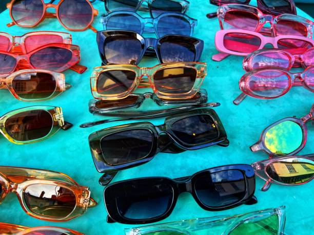 istock Colourful plastic sunglasses retail display on turquoise table 1437309357