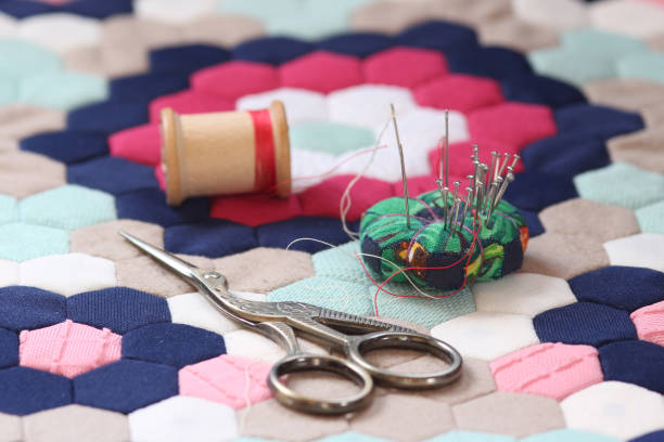 istock Quilting supplies on a colorful hexagon mosaic patterned quilt 1437311174