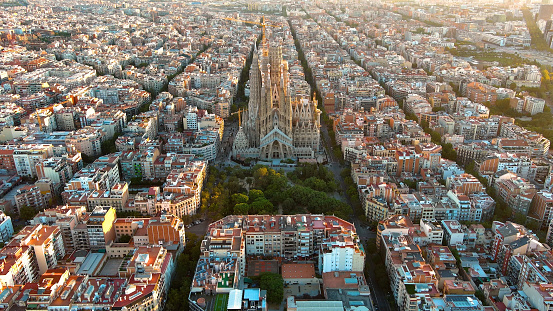 Barcelona city skyline with Sagrada Familia Cathedral at sunrise. Catalonia, Spain. Cityscape with typical urban octagon blocks